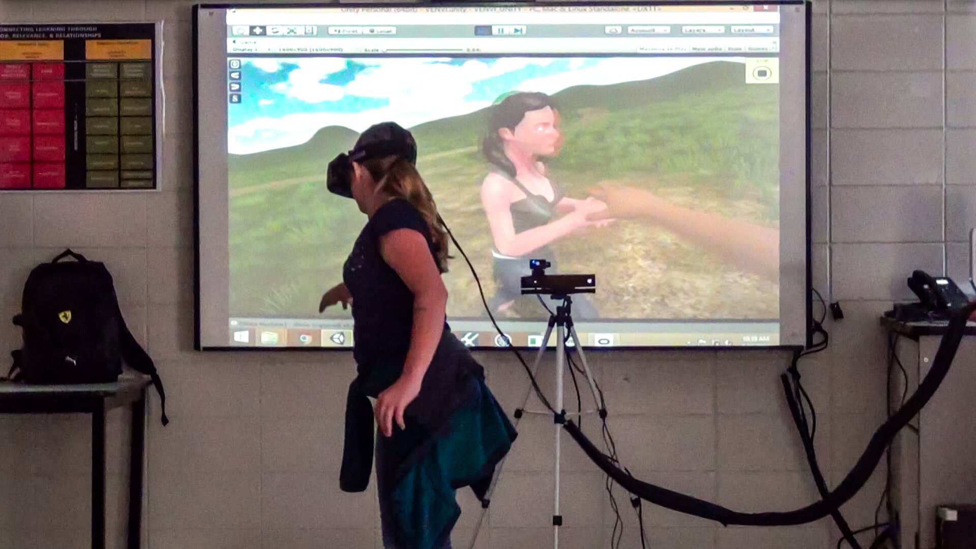 A student trying to reach out to her character within VR.